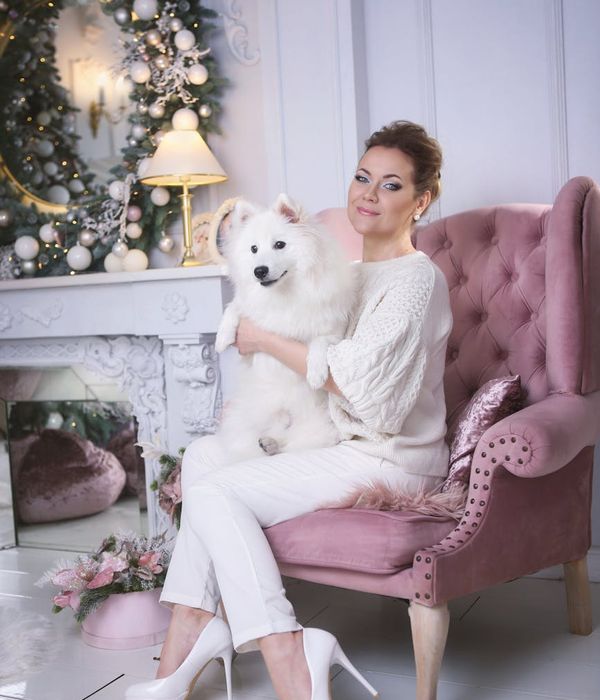 Woman performing a gentle yoga pose in a calm, dark environment with blue light.